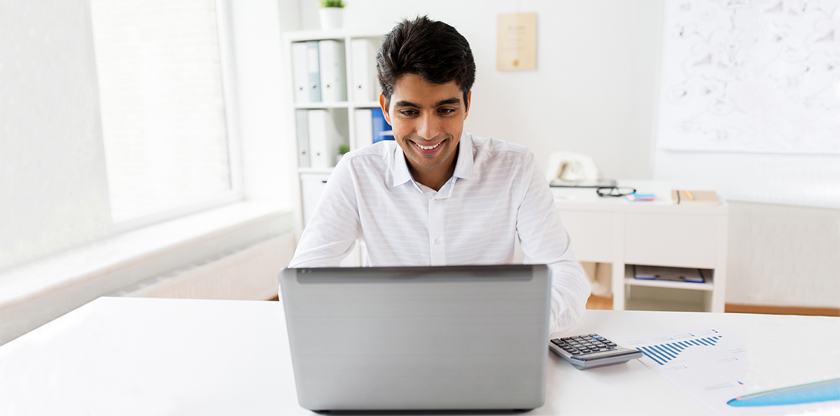 accountant with laptop and papers at office