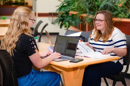 Two girls studying at a table