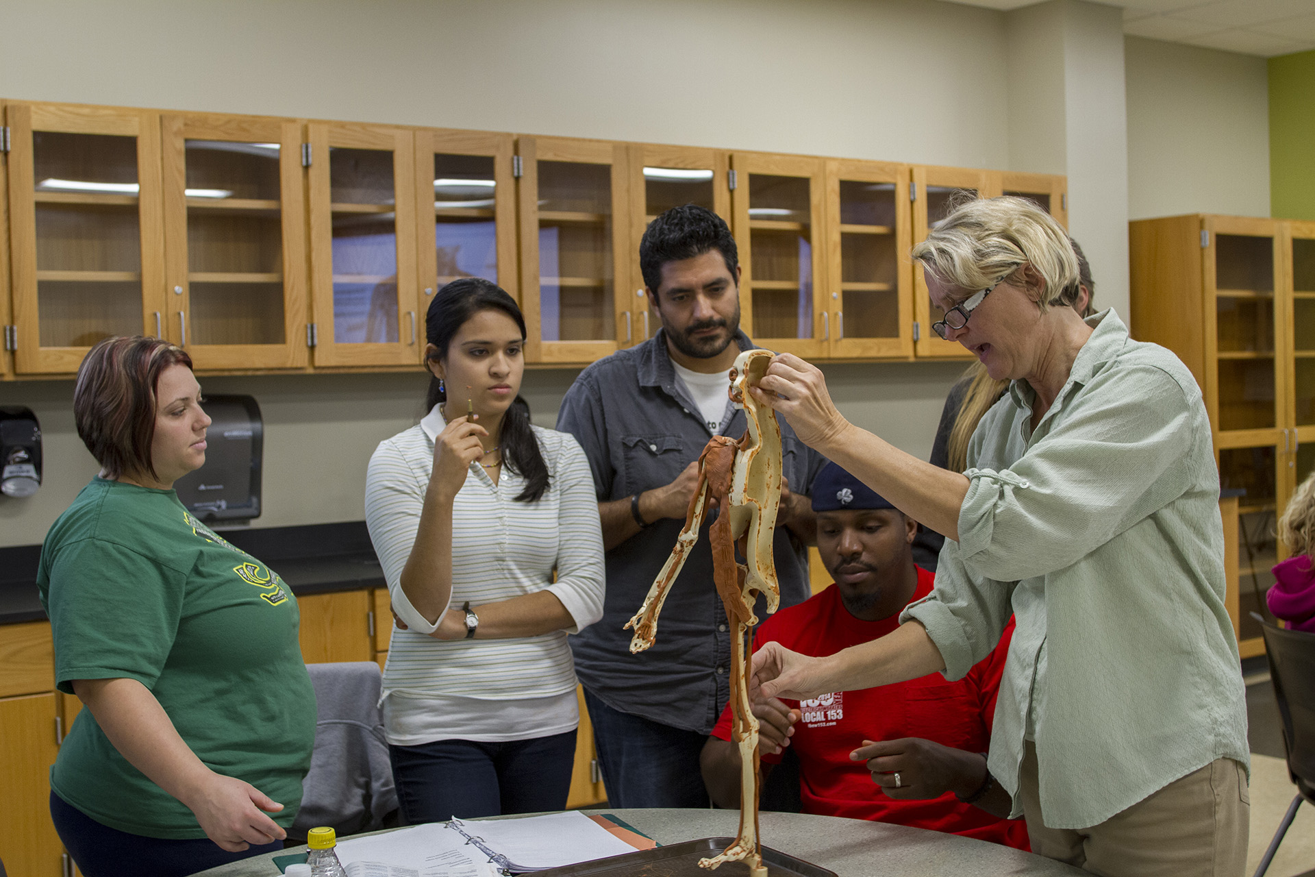 An instructor demonstrating muscles to students