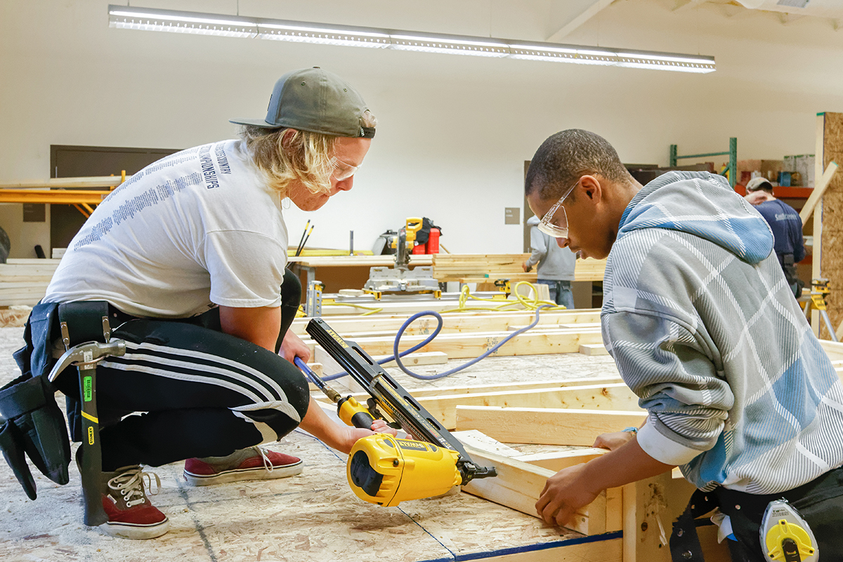 Two students learning about construction trades