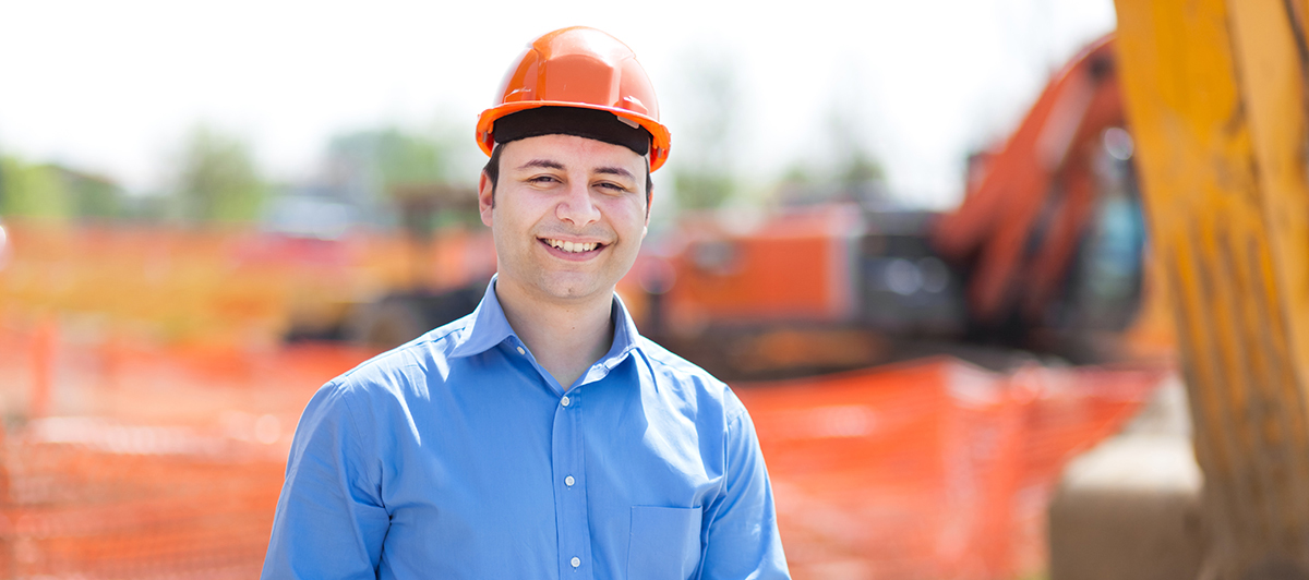 Man at  Construction Site with Blueprints