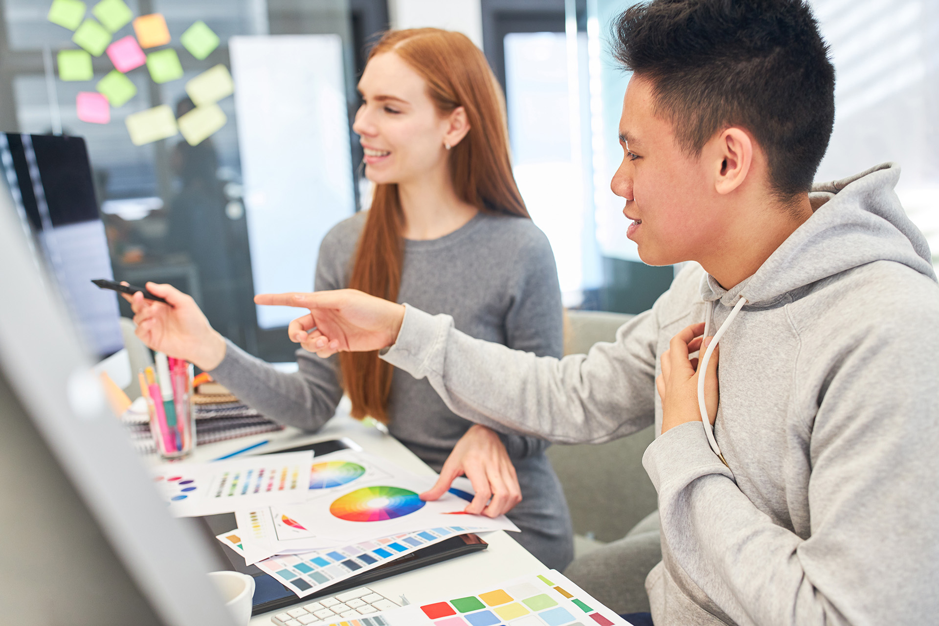 Students reviewing color samples in front of a computer