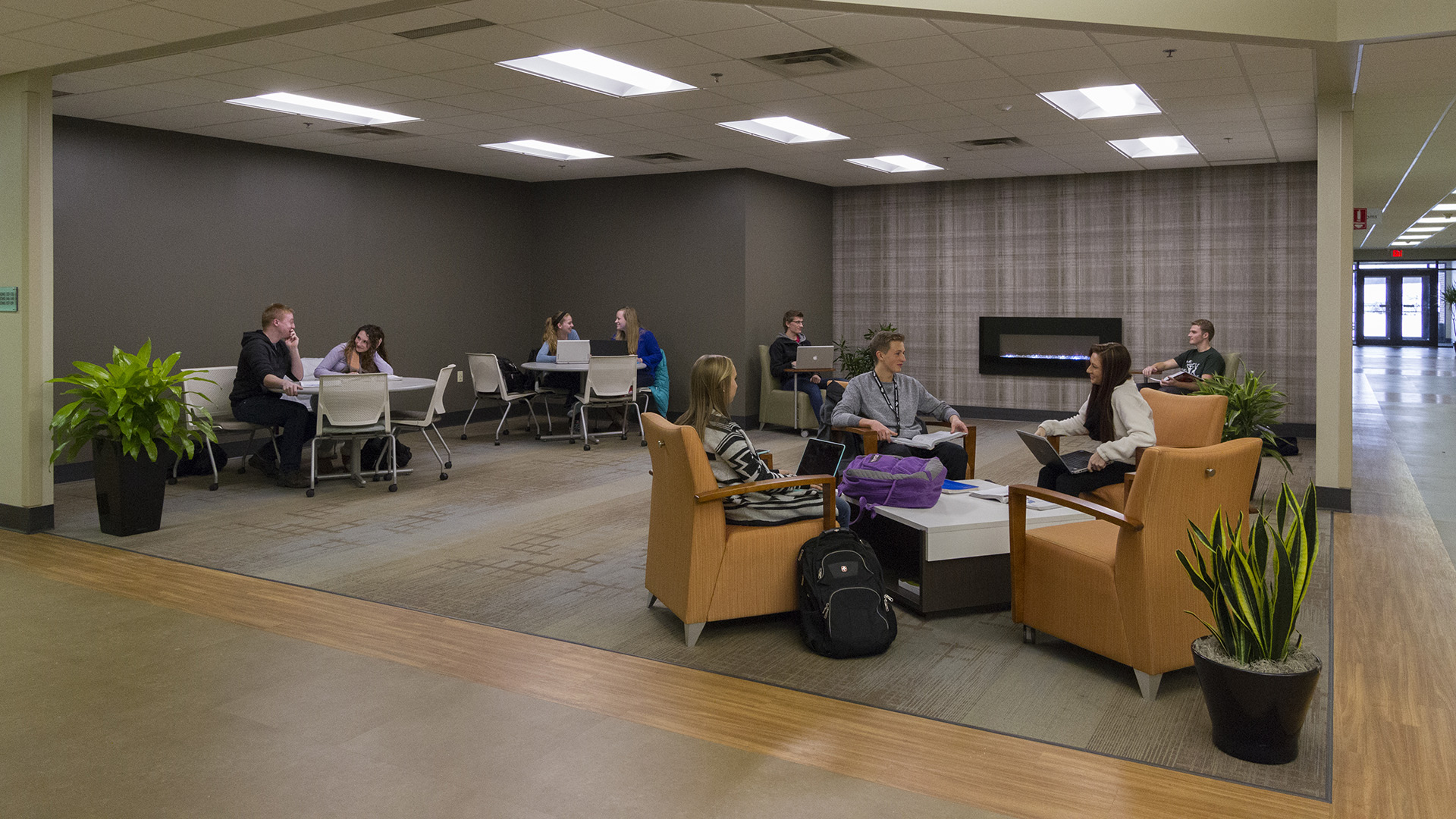 Students studying near the fire place on the Niles Campus