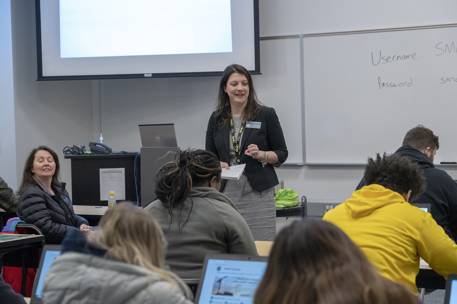 A staff member instructing students at orientation