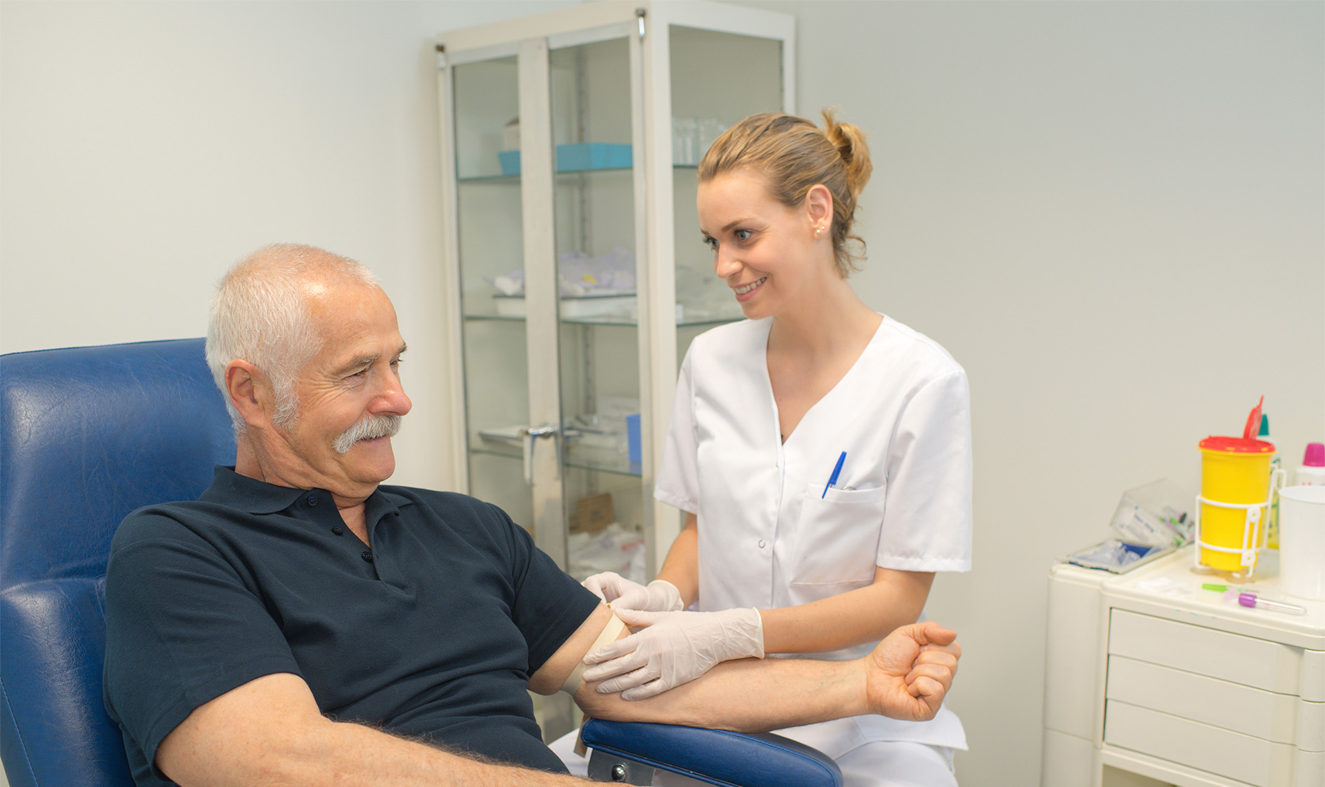 Phlebotomist collecting patients blood for test.