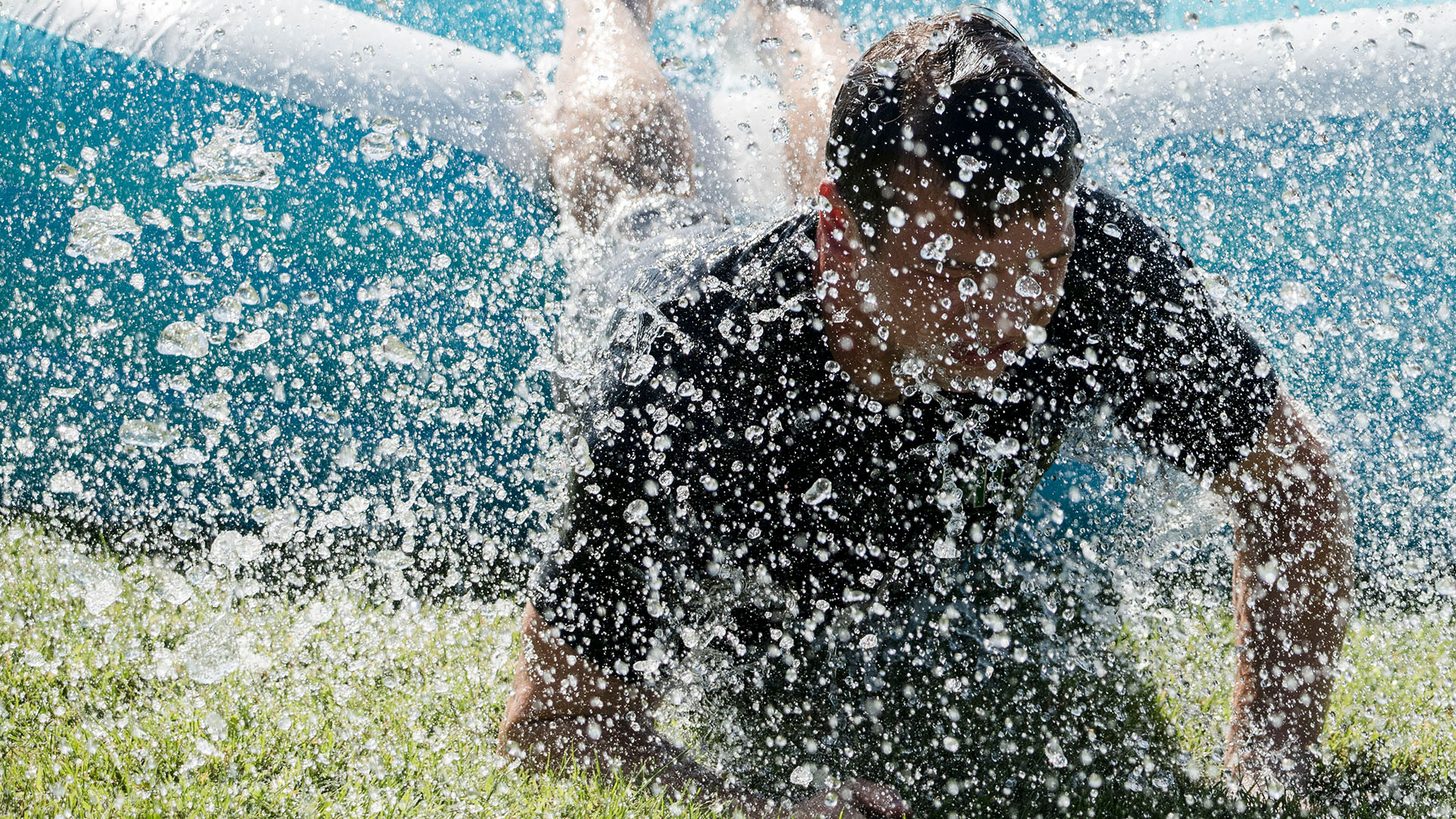 Student enjoying slip n slide during Welcome Week