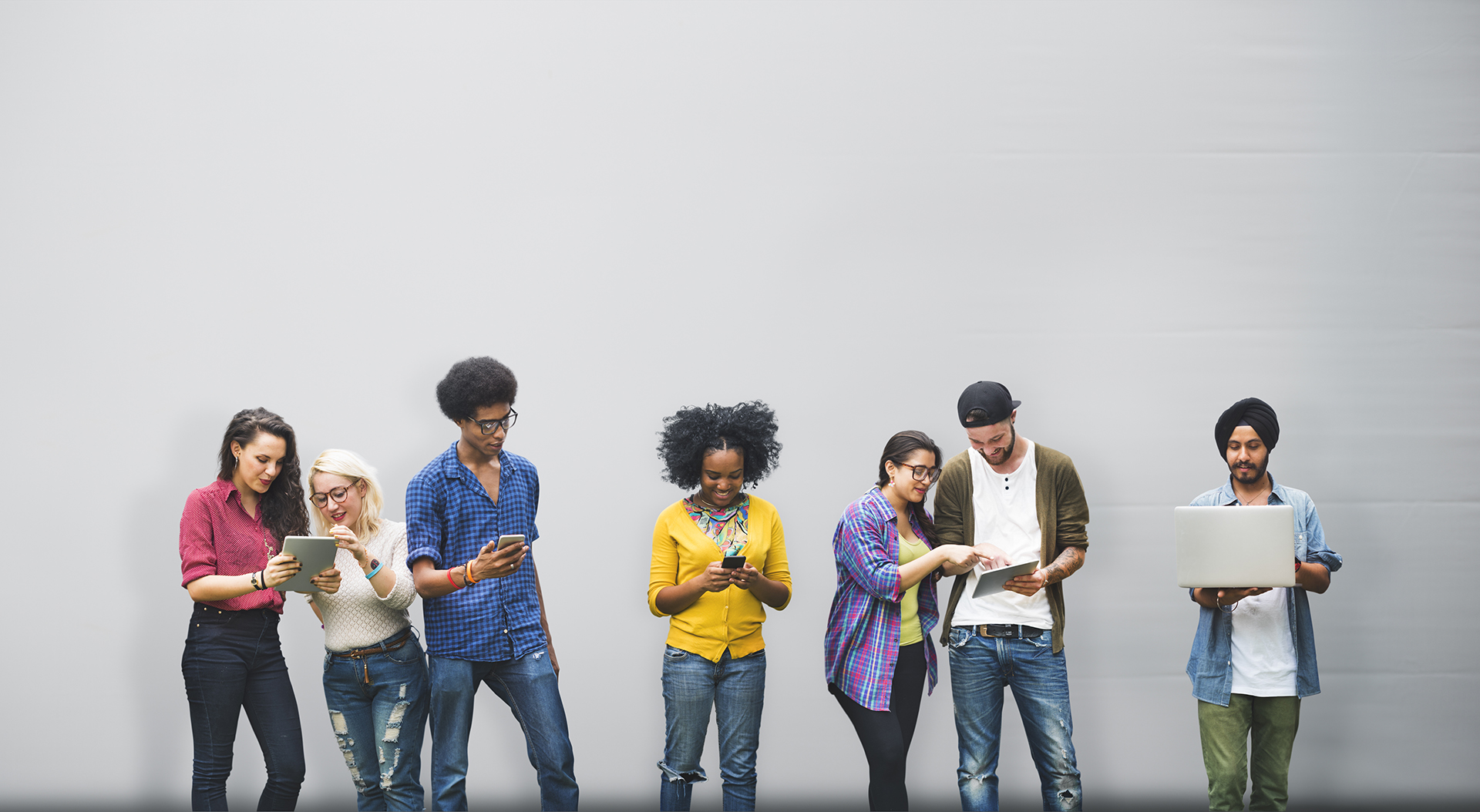 Young people looking at devices together