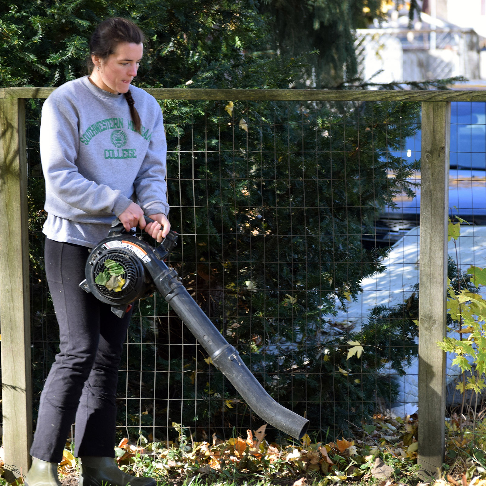 Rachel Breden blows leaves in Dowagiac