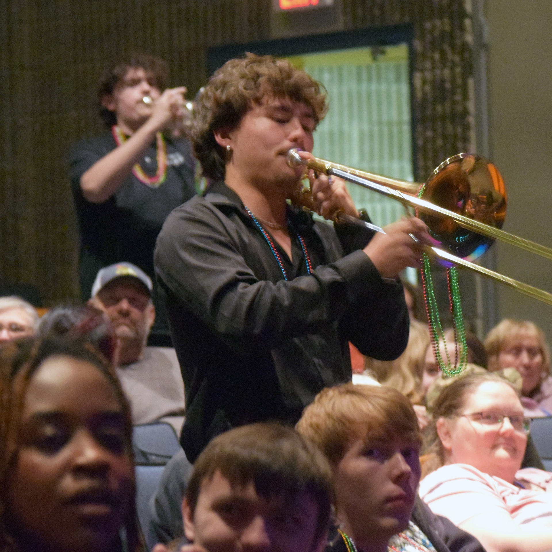 Musicians marched in draped with beads
